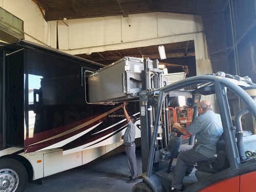 Appliance maintenance: RV refrigerator being replaced through the window on a class A motorhome